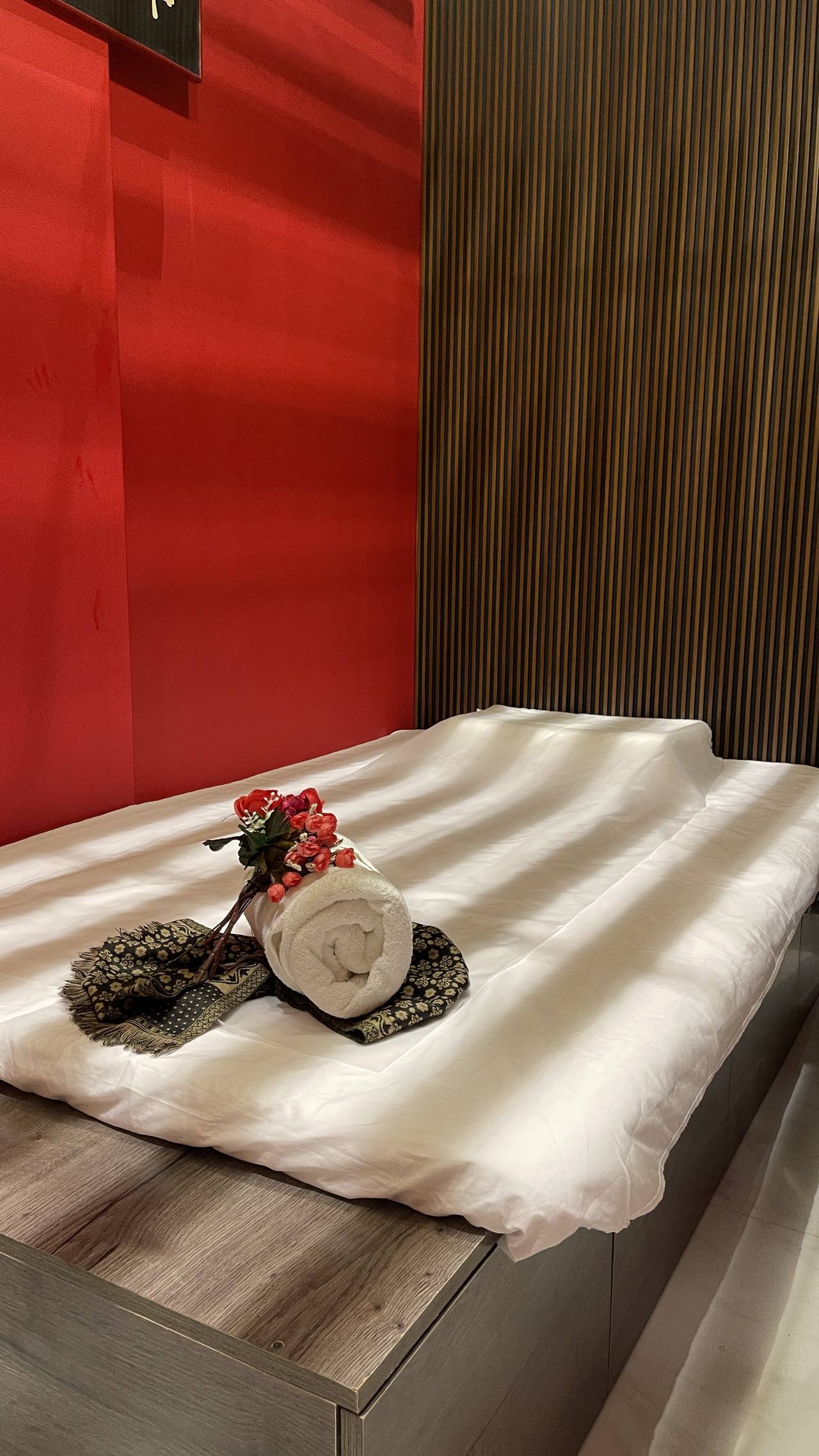 Rolled towel with floral decor at Wifi Spa